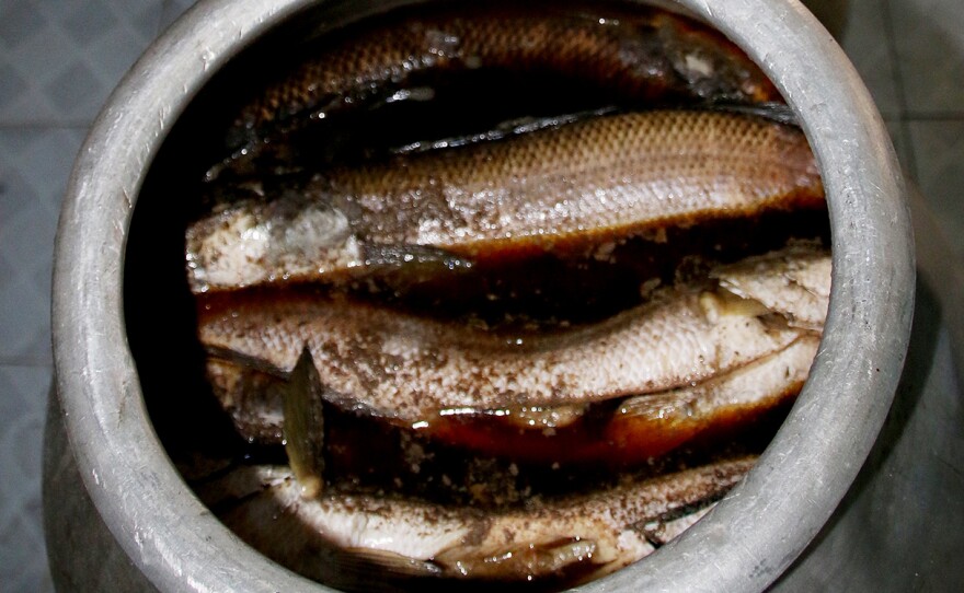 Myaungmya Daw Cho in Yangon buys catfish for its mohinga from local farms in the Irrawaddy Delta. It is first soaked for half an hour in a fermented fish sauce in large pots.