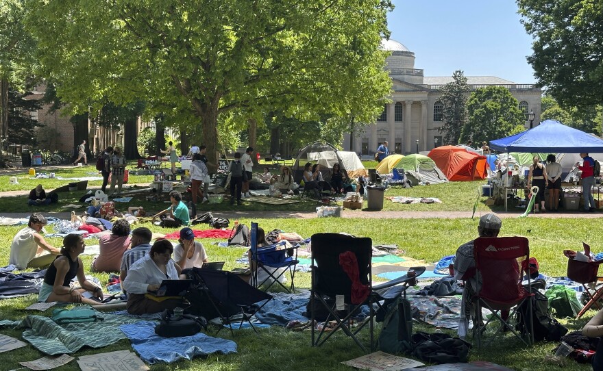Students work on assignments and listen to organizers as they sit inside the encampment protest in Polk Place on University of North Carolina at Chapel Hill, N.C., on Monday.