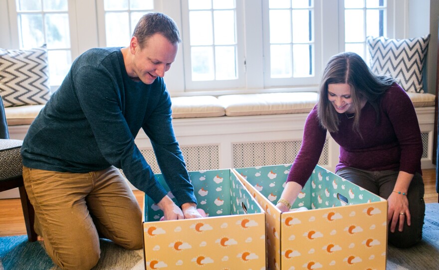 Dave and Kyle Stimpert check on Ryan and Nell. They received the free boxes after learning about preventing SIDS through safe sleep practices.