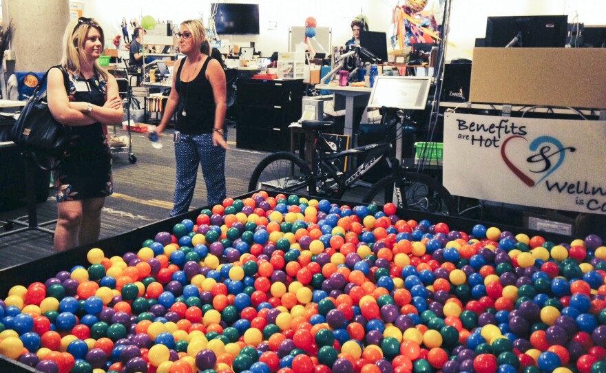 Zappos.com tour guide Erika Newman (right) shows off the ball pit in the human resources department of the company's Las Vegas headquarters. Zappos has eliminated its managers and embraced a system of self-governance known as a holacracy.