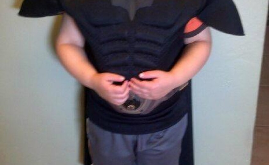 The kid behind the mask: Miles Scott, 5, is a happy superhero today.