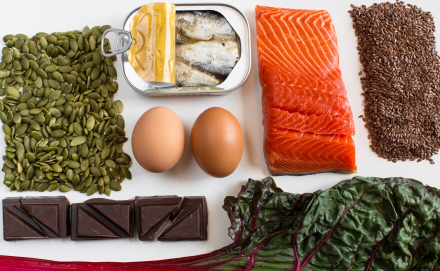 A nutrient-dense diet may help tamp down stress. And these foods may help boost our moods: (Clockwise from left) pumpkin seeds, anchovies, eggs, salmon, flax seeds, Swiss chard and dark chocolate.