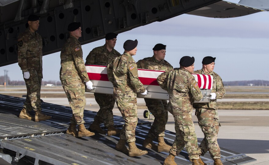 In this Dec. 25 photo, an Army carry team moves a transfer case containing the remains of U.S. Army Sgt. 1st Class Michael Goble, at Dover Air Force Base in Delaware. The U.S. Special Forces soldier died in Afghanistan this week while seizing a Taliban weapons cache.