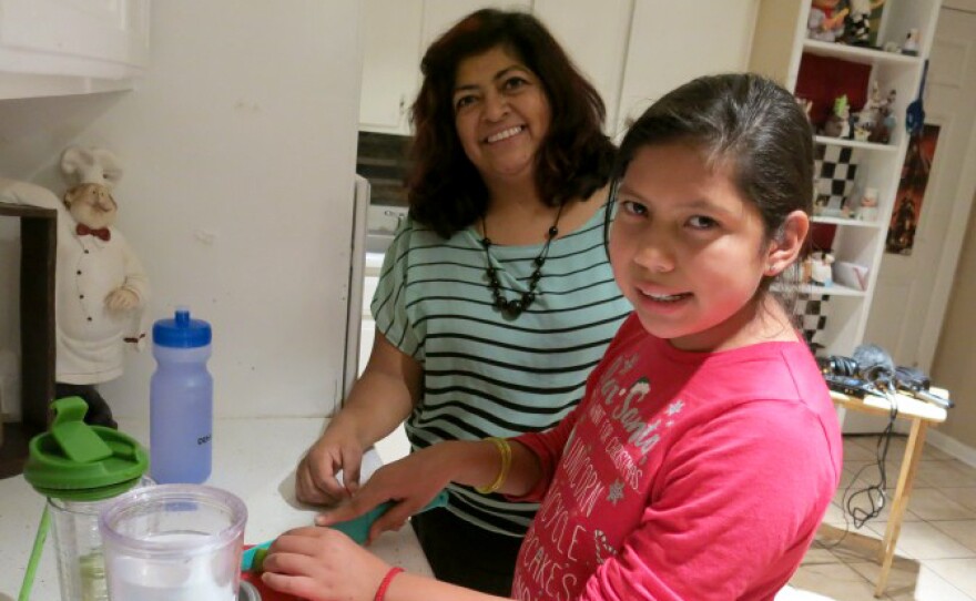 Gabriela Medina, and her daughter Andrea, in the family kitchen. The 10-year-old says she and many of her friends at school have started drinking less soda and more water they bring from home.