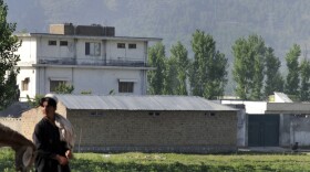 A Pakistani shepherd walks past the hideout of Al-Qaeda leader Osama bin Laden who was killed by US Special Forces in a ground operation early May 2, in Abbottabad on May 4, 2011.