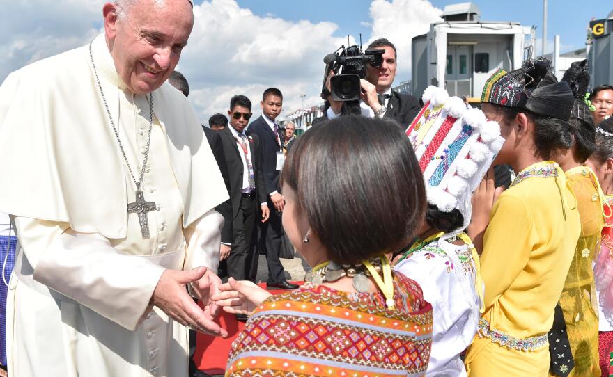 In this image provided by L'Osservatore Romano, Pope Francis arrives in Yangon, Myanmar, on Monday.