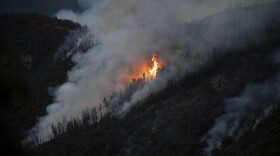 Flames from the Ferguson Fire burn down a hillside in unincorporated Mariposa County Calif., near Yosemite National Park on Sunday, July 15, 2018.