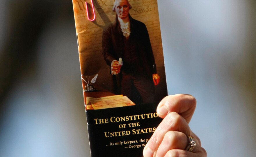 A demonstrator holds up a pocket-sized copy of the U.S. Constitution during a health care rally organized by The American Grassroots Coalition and The Tea Party Express on Capitol Hill in March.