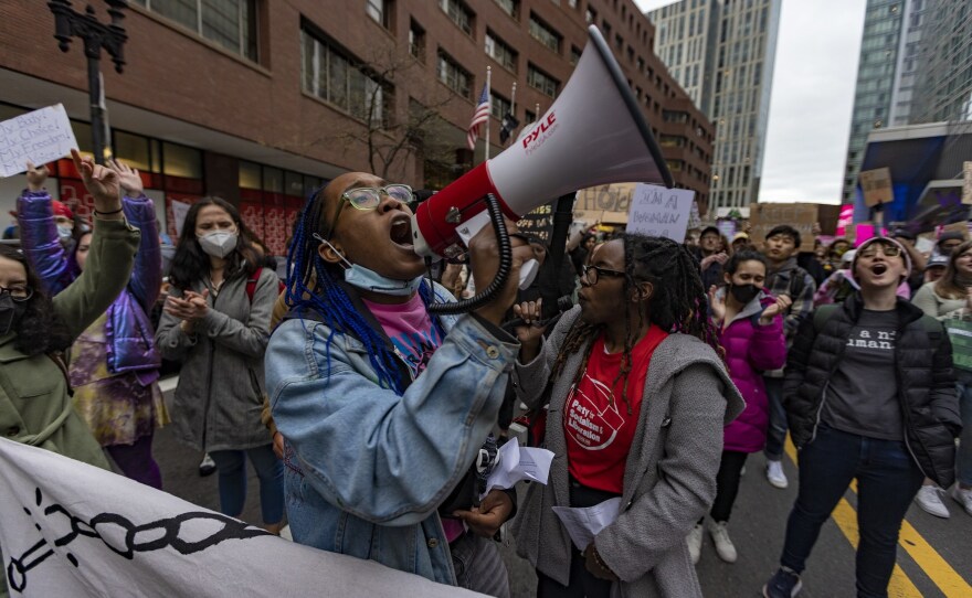 <strong>BOSTON:</strong> A protester chants through a megaphone as thousands of protesters march down Stuart Street during the Defend Abortion Rights rally.