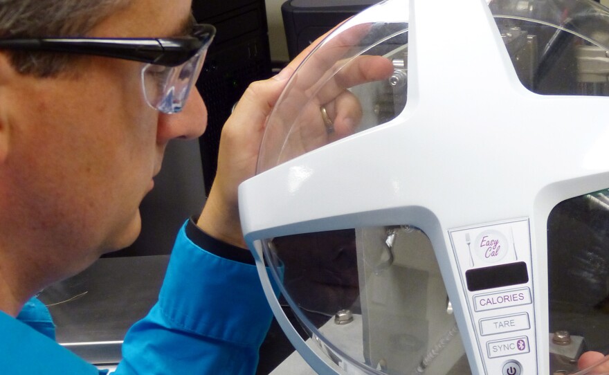 GE scientist Matt Webster demonstrates how the calorie counter he is developing would work.