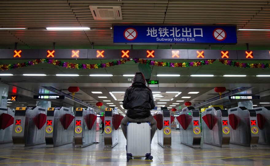 Millions of Beijing residents are expected to return to the capital city after going away for the Lunar New Year. Above: A traveler at Beijing's West Railway Station on Sunday.