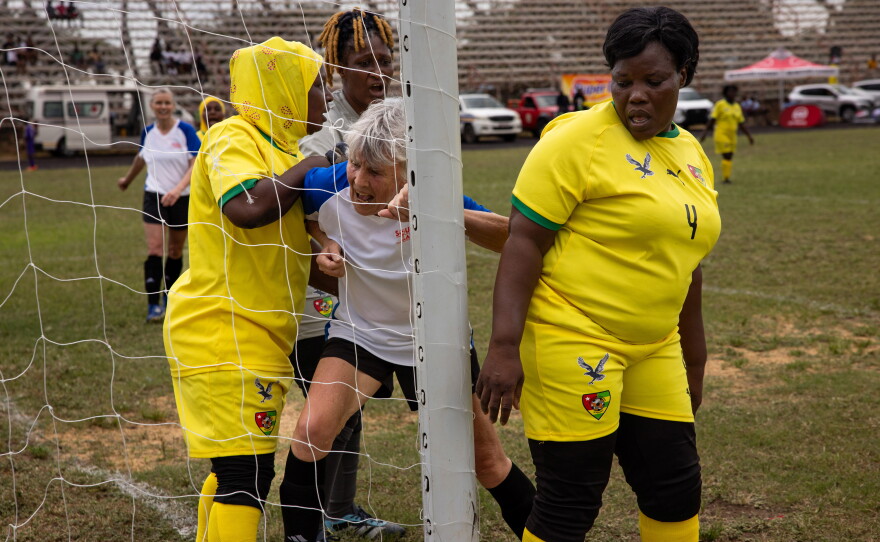 Sue "Clip" Clippinger, 78 (in the white t-shirt), is the center forward for the New England Breakers. She's flanked by players from team Togo. "We've got some of the best chemistry," Clippinger says of her team, adding "I've gotten better at this than when I was 40."