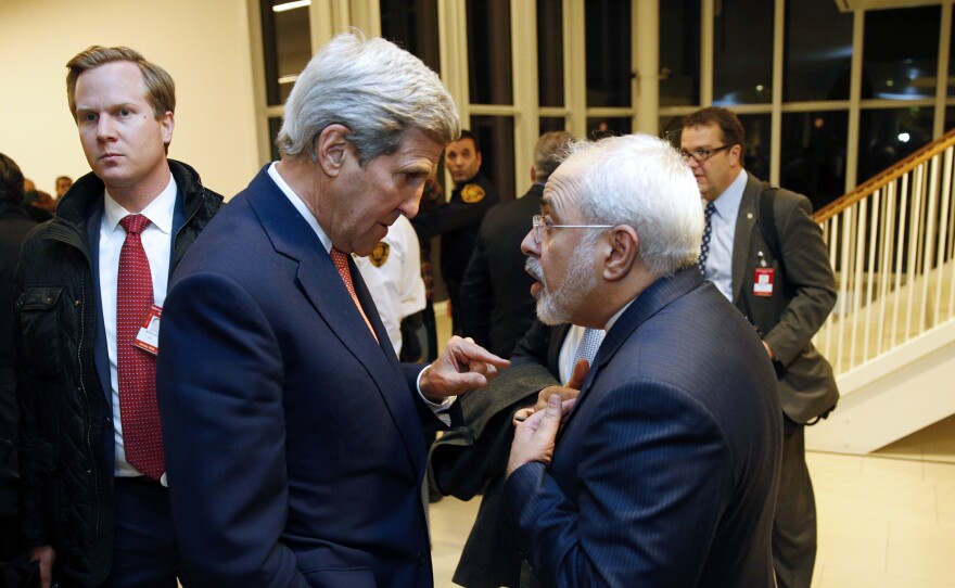 Secretary of State John Kerry speaks with Iranian Foreign Minister Mohammad Javad Zarif in Vienna on Jan. 16. The nuclear accord between Iran and major powers entered into force as the U.N. confirmed that Tehran had shrunk its atomic program and sanctions were lifted.