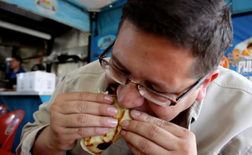 Host Jorge Meraz enjoys a taco.