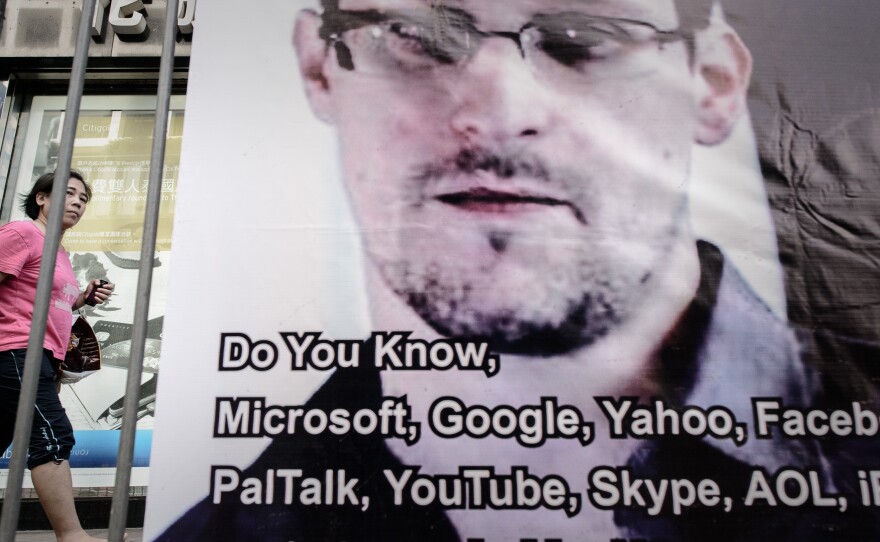 A woman in Hong Kong walks past a banner displayed in support of Edward Snowden this week.