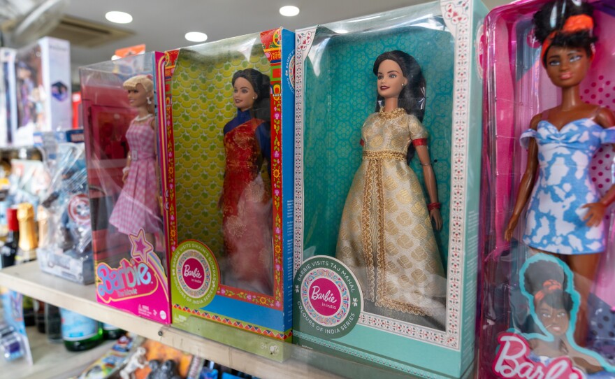 The original blond Barbie sells well in India but an Indian version with dark hair and Indian-style garments did not catch on. In this store display, Indian Barbies are flanked by a fair-haired doll and an African American Barbie.