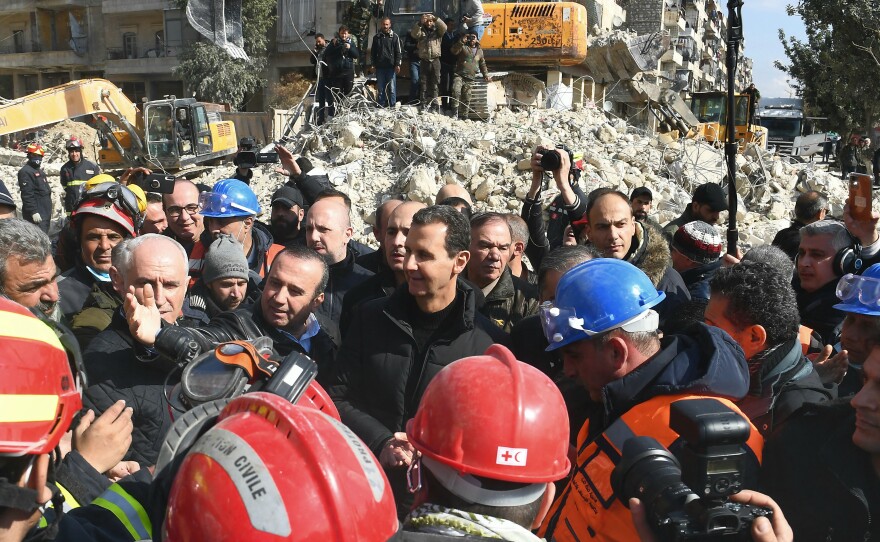 Syrian President Bashar al-Assad (center) visits neighborhoods affected by the earthquake in the northern city of Aleppo.