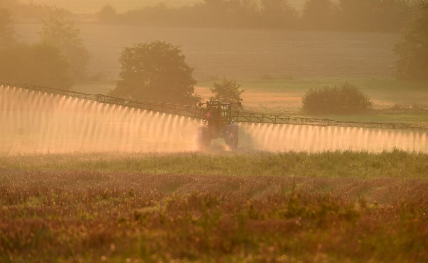 Bayer says a settlement worth more than $10 billion will resolve most of the roughly 125,000 claims the company currently faces over its Roundup product. Here, a farmer sprays the glyphosate herbicide in northwestern France in September.