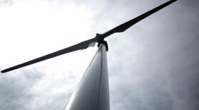 A growing number of companies are offering customers a chance to buy green power, a combination of electricity from the local grid combined with renewable energy credits from wind farms. Above, a wind turbine in Harris, Iowa.