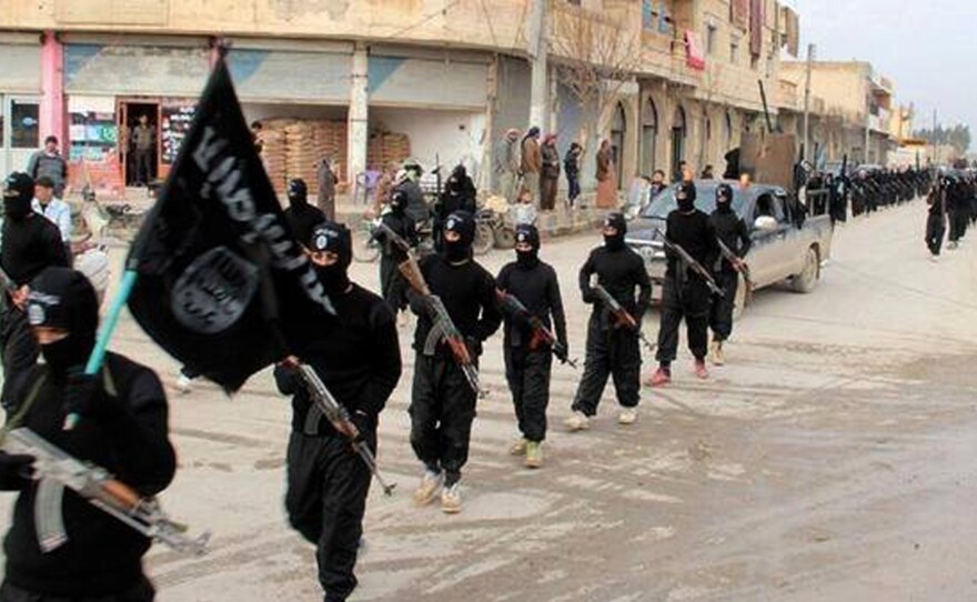 Islamic State fighters march in Raqqa, Syria. The group has killed five Western hostages in recent months. In the 1990s, many radical Islamist groups gave interviews to journalists and refrained from kidnapping Westerners.