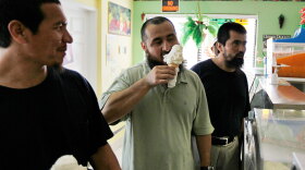 Former Guantanamo detainees (left to right) Khelil Mamut, Ablakim Turahun, and Salahidin Abdulahat eat ice cream at a shop near Hamilton, on the island of Bermuda, in June. The three Chinese Uighurs were released from U.S. military custody after years in the prison. The Supreme Court agreed Tuesday to take up the question of the other Uighurs being held at Guantanamo even though they are not considered a threat to the U.S.