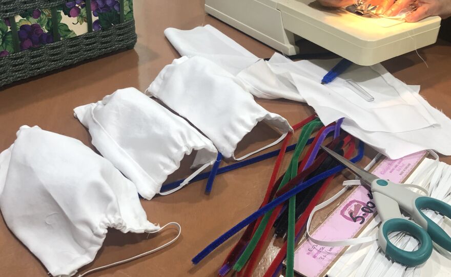 Cotton surgical masks sewed by Milli and Shobna Desai are seen displayed on a table, March 25, 2020.