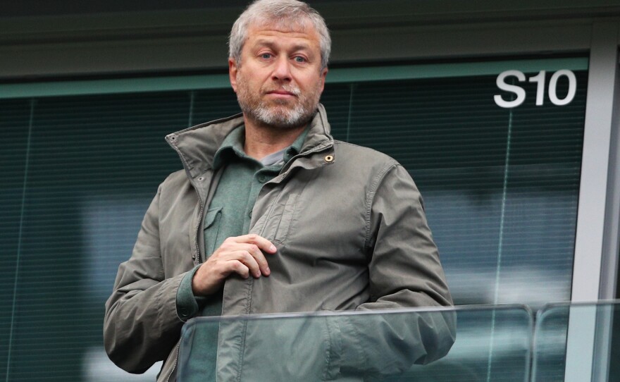 Roman Abramovich, pictured at a 2016 match in London, is facing an asset freeze and U.K. travel ban just a week after he announced plans to sell Chelsea Football Club.