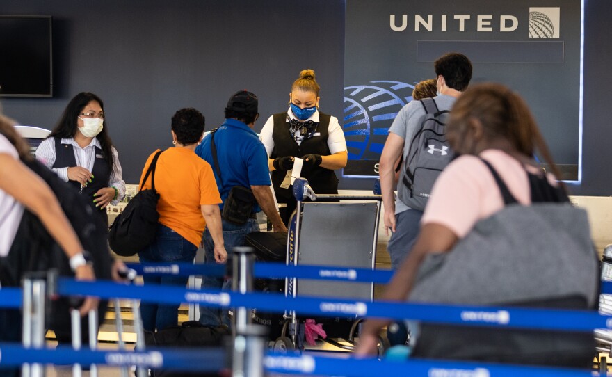 Travelers line up to check in for United Airlines flights at Newark Liberty International Airport on July 1, 2022 in Newark, N.J. Experts are predicting heavy travel this summer.