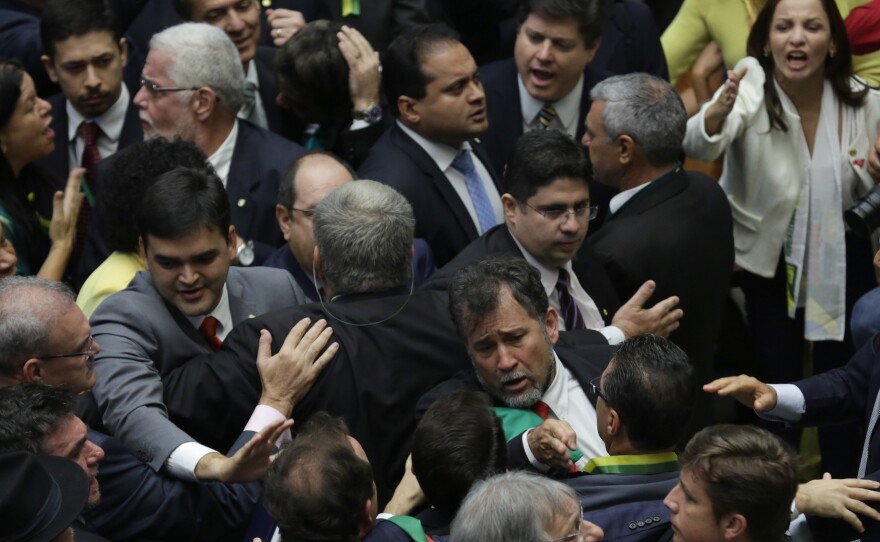 Pro-government and opposition lawmakers scuffle in the Chamber of Deputies as Brazil's lower house of Congress voted to support the impeachment of President Dilma Rousseff.