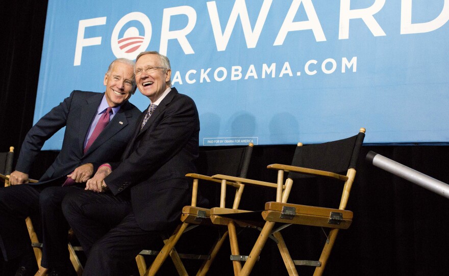 Vice President Biden (left) and Senate Majority Leader Harry Reid of Nevada react to cheers from the crowd at a campaign rally on Oct. 18, 2012, in Las Vegas.