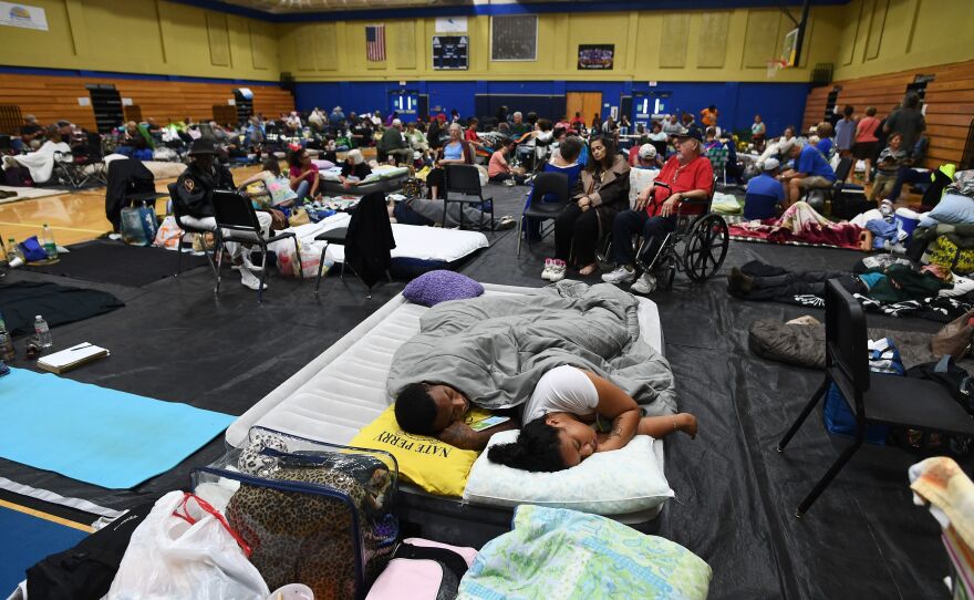 Local residents take shelter at Pedro Menendez High School in St. Augustine, Fla., on Thursday. Some 1.5 million people are under evacuation orders in Florida in preparation for Hurricane Matthew.