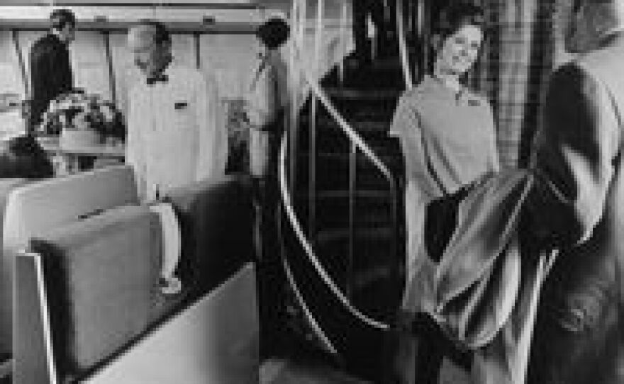 An air hostess greets a passenger in front of the spiral staircase leading to the upper deck lounge in a Boeing 747 in 1970.