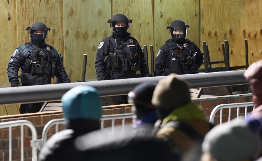 Police stand during a noise demonstration outside the Graduate by Hilton Minneapolis hotel on Jan. 28, 2026.