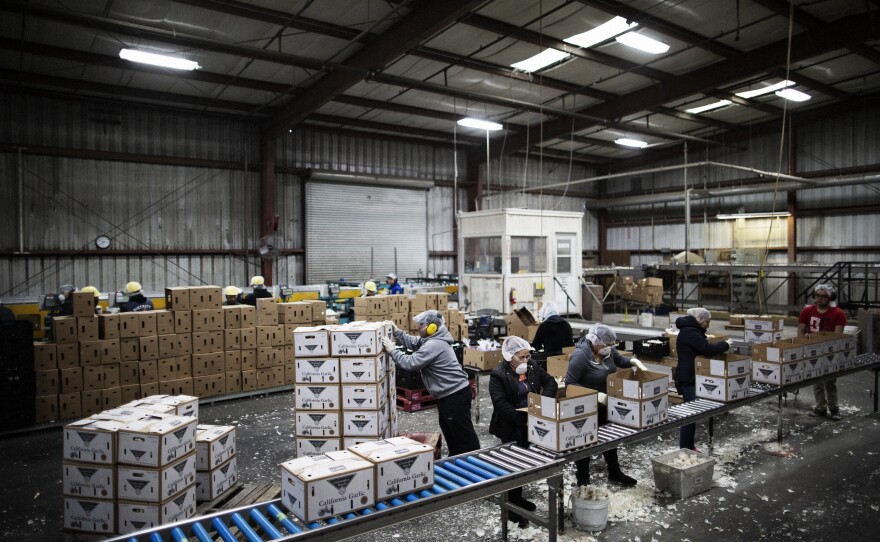 Workers pack garlic into boxes at the plant. Ken Christopher, the company's executive vice president, said that when the Trump administration announced tariffs on China, "My coworkers and I started texting each other, emails started flying back and forth."