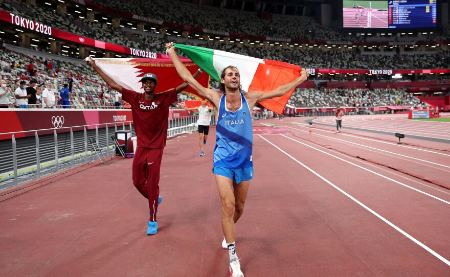 Gold medalists Mutaz Essa Barshim, left, of Team Qatar and Gianmarco Tamberi of Team Italy celebrate on the track following the Men's High Jump Final on August 1.
