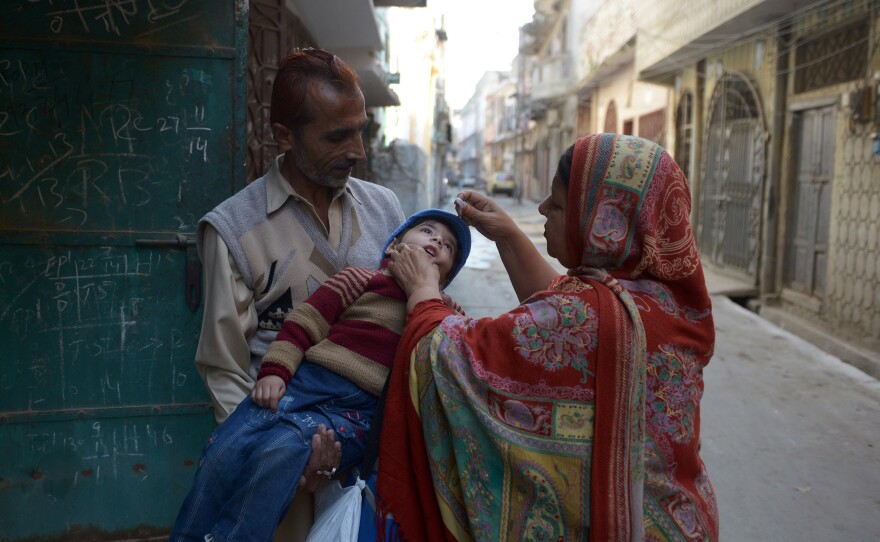 A Pakistani health worker administers a polio vaccine to a child during a campaign in the northern city of Rawalpindi.
