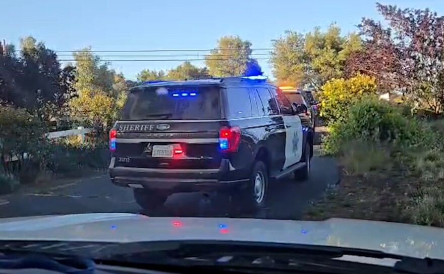 Law enforcement vehicles are shown entering the Villa Chardonnay on May 1, 2026.