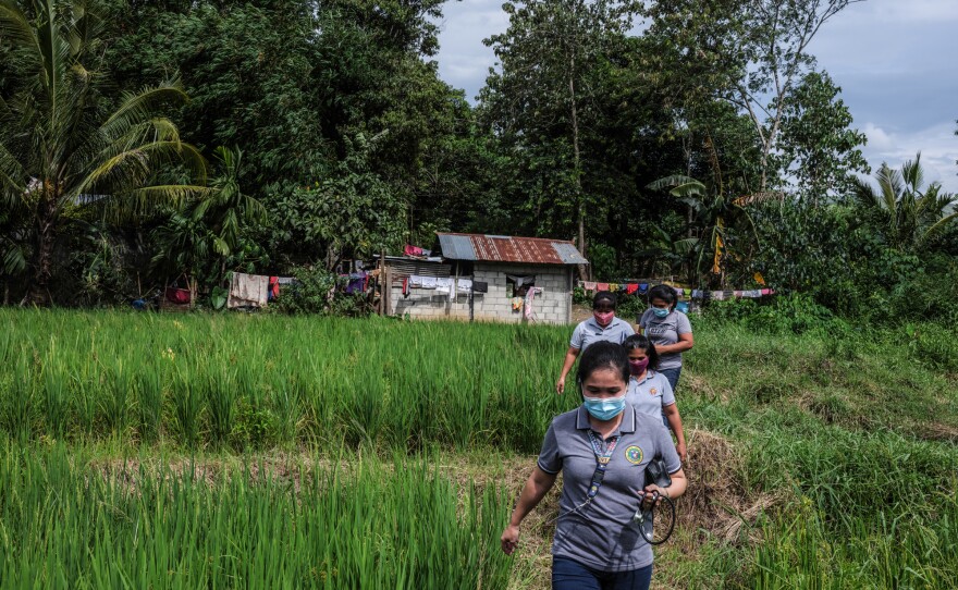 Marissa Tuping, a rural midwife and health-care worker, walks to visit pregnant mothers in the village of Abinganan.