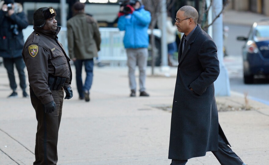 Baltimore police Officer Caesar Goodson (right) walks past Deputy Donald Rheubottom before entering a courthouse in Baltimore in January. Goodson, one of six Baltimore police officers charged in connection with the death of Freddie Gray, goes on trial starting Thursday.
