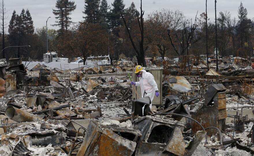 Work crews remove debris at the site of a home destroyed by fires in the Coffey Park area of Santa Rosa, Calif., last month. Thousands of homes and other structures were destroyed by wildfires in the area.