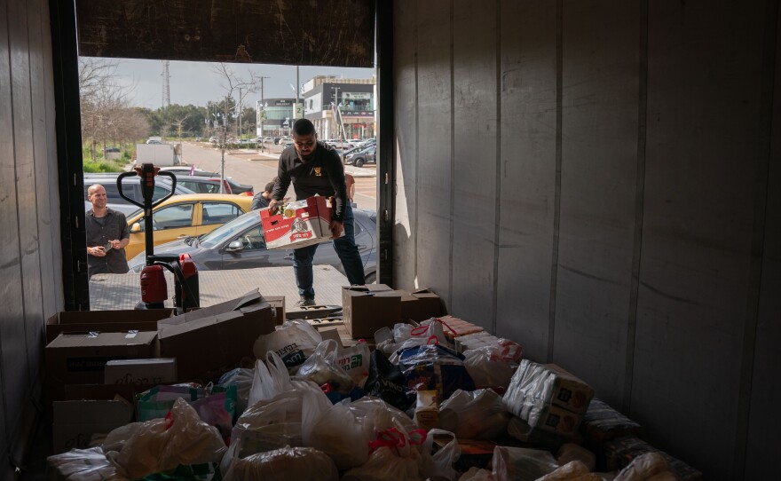 Activists from Standing Together set out in a convoy, including a large truck holding donated dried goods and cans, with the goal of delivering aid directly to Gaza on March 7. The group was blocked en route to Israel's Kerem Shalom border crossing with Gaza by Israeli police and soldiers.