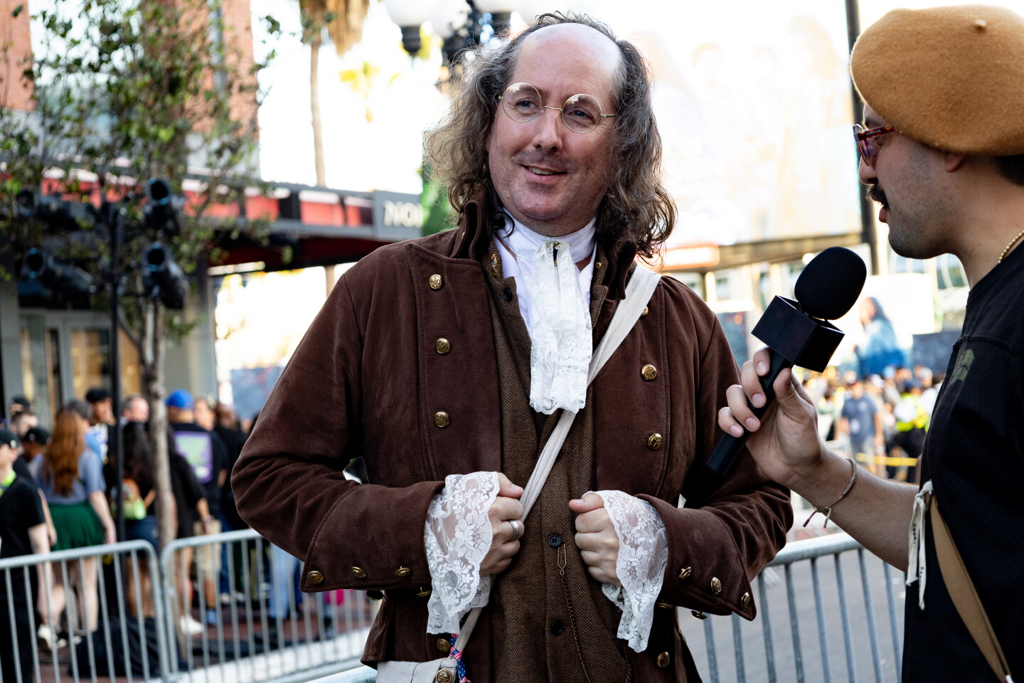 A Comic-Con attendee dressed a Benjamin Franklin is interviewed in the Gaslamp on July 24, 2026.