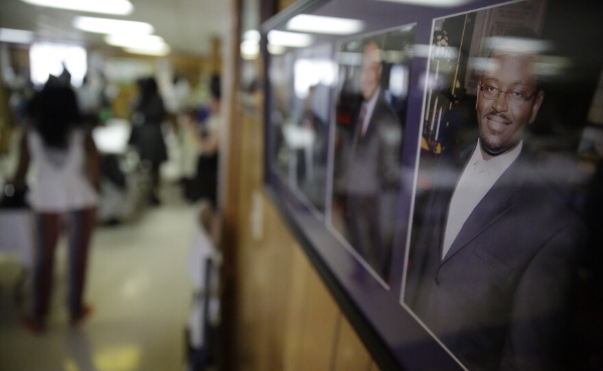 A portrait of the Rev. Clementa Pinckney, right hangs on a wall, June 21, 2015, in Charleston, S.C., in the basement of Emanuel A.M.E. Church where the killing of the pastor and eight others occurred in a mass shooting. 