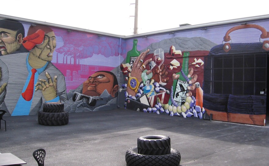 The second wall of Nunca's mural references Miami's material culture.