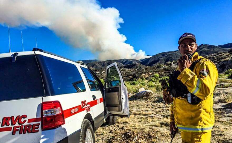 A Cal Fire firefighter from Riverside helps fight the Cutca fire near Palomar Mountain in the Cleveland National Forest, July 24, 2015.