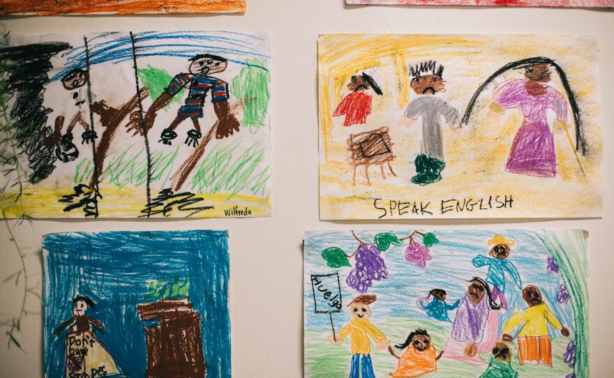 Drawings hang on the walls at Las Familias Del Pueblo.
