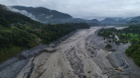 A drone view shows a major section of Pasang Lhamu highway washed away along swollen Trishuli river by recent flash floods cutting off Rasuwa district from Nuwakot area, Nepal, Monday, Aug. 31, 2026.