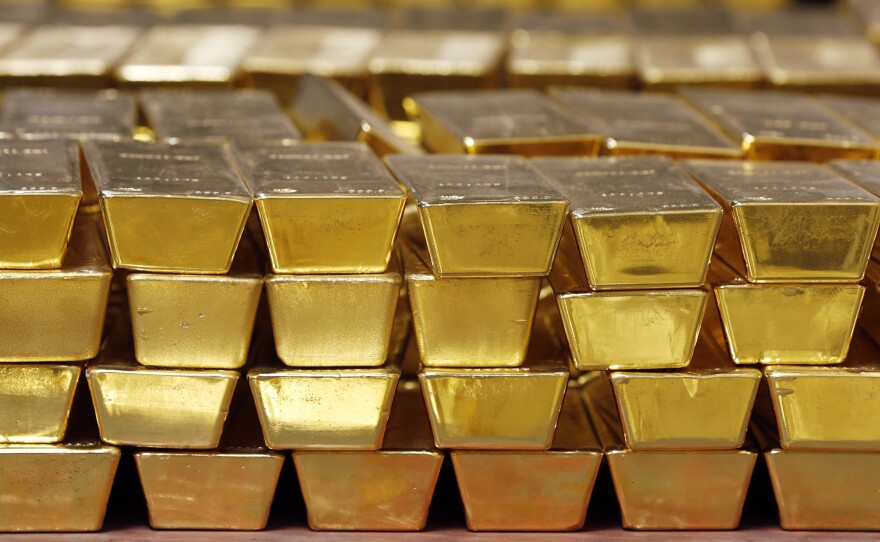 Gold bars are stacked in a vault at the United States Mint, in West Point, N.Y., in 2014. The settlement price for gold futures reached a record high of $1,931 per ounce Monday — and many analysts predict the price will head even higher.