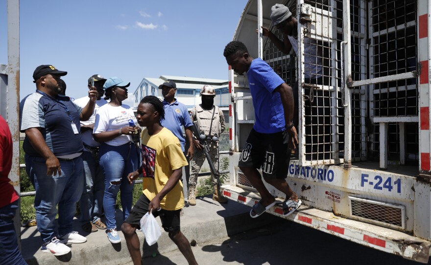 Haitian citizens who were detained by the Dominican Republic's authorities arrive at the Haitian border for deportation, on Wednesday.