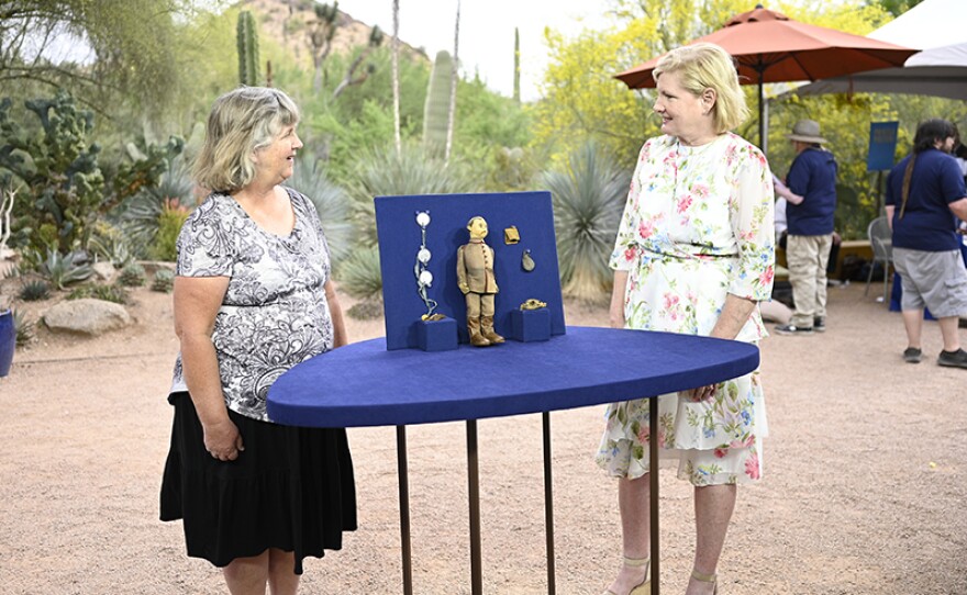 Billye Harris (right) appraises a Steiff German soldier doll set, ca. 1915, at Desert Botanical Garden in Phoenix, Ariz.